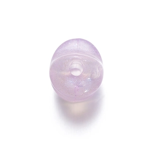 Macro detail of a translucent purple acrylic star bead with glitter for DIY jewelry