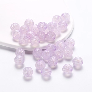 Macro detail of pumpkin shaped acrylic beads in lavender purple for DIY jewelry making