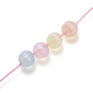 Macro detail of pastel acrylic pumpkin beads with pearl coating for DIY jewelry making