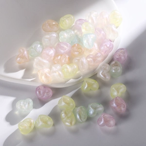 Pearlescent acrylic heart beads in macaron colors for DIY jewelry making in a white bowl