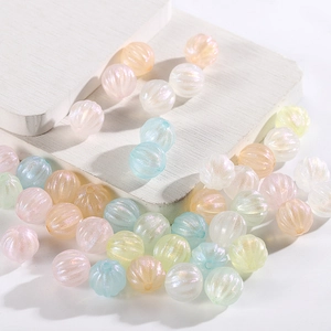 Macro shot of colorful acrylic pumpkin beads with iridescent mermaid finish for DIY crafts