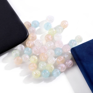 Macro detail of acrylic pumpkin beads with AB rainbow coating for DIY jewelry making