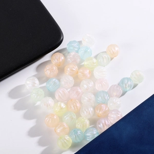Macro shot of iridescent ribbed acrylic beads in macaron colors for DIY jewelry making