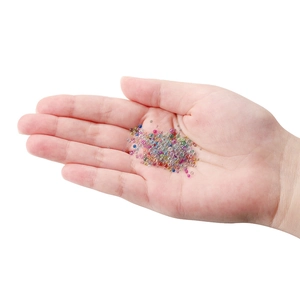 Close-up of colorful glass bubble beads in palm showing 1-3mm size for DIY nail art