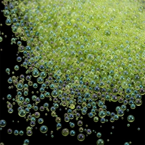 Macro shot of iridescent lime green glass micro beads for DIY resin and nail art deco