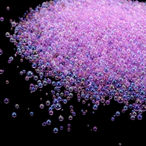 Macro shot of purple iridescent glass bubble beads for DIY resin and nail art deco