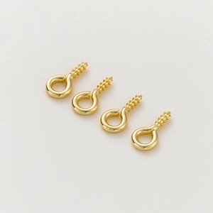 Detailed view of four gold-plated screw eye pins for jewelry making and DIY pendants