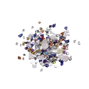 Close-up of colorful irregular glass crystals and mixed sand for nail art and DIY crafts