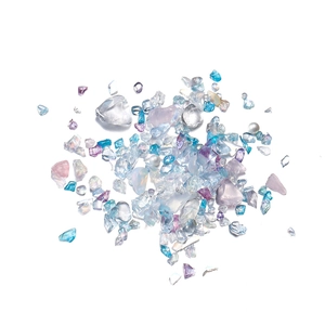 Close-up of irregular mixed crystal crushed stones and tiny white pearls for DIY nail art