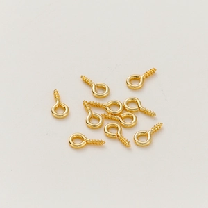 Detailed view of 10 gold-plated eye pins with screw thread for DIY jewelry making