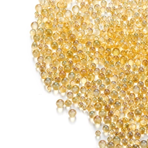 Macro view of transparent golden glass bubble beads for DIY jewelry and nail art