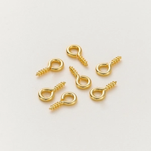Macro shot of 14K gold plated eye pins for DIY jewelry making and pendant crafting