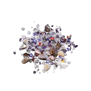 Close-up of irregular iridescent crystal glass sand and crushed stones for DIY nail art