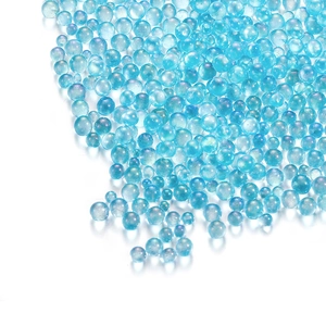 Macro shot of light blue iridescent glass bubble beads for DIY jewelry and nail art