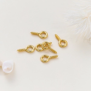 Detailed view of 14K gold plated screw eye pins for DIY jewelry making and pendant crafts