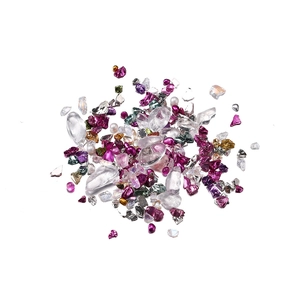 Macro detail of mixed iridescent crushed glass and colorful beads for DIY nail art and crafts