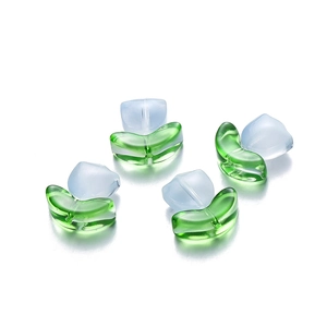 Detailed close-up of blue tulip glass beads with green leaves and center drill hole