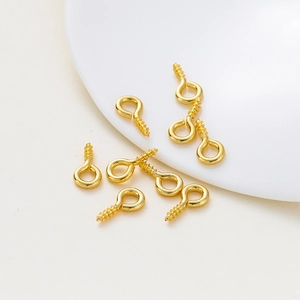 Macro shot of 14K gold-plated screw eye pins for DIY jewelry making accessories