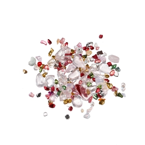 Close-up of mixed colorful crystal crushed stones, pearls and metallic flakes for DIY crafts