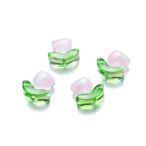 Detailed view of four pink and green glass tulip flower beads for DIY jewelry making