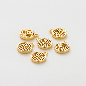 Macro shot of 18K gold-plated circular Fu character charms for DIY jewelry making