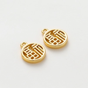 Close-up of dual 18K gold-plated Fu pendants with hollow-out Chinese character design