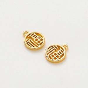 Detailed view of hollowed 18K gold-plated Fu pendants for DIY jewelry making