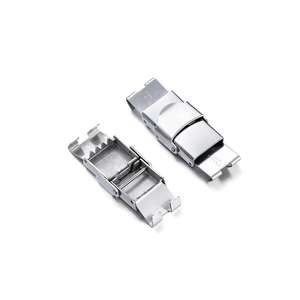 Macro view showing brushed stainless steel watch buckle details and folding mechanism