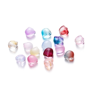 Macro view of colorful heart-shaped glass beads with gold foil for DIY jewelry making