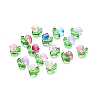 Macro detail of tulip glass beads with green leaves for DIY jewelry making
