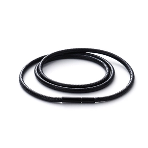 Detalle macro del cordón de cera trenzado negro con cierre metálico cilíndrico liso