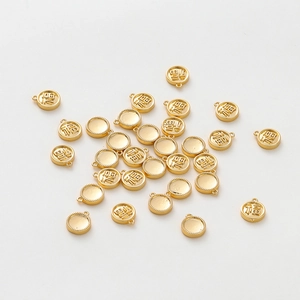 Detailed view of 18K gold-plated Fu character pendants for DIY jewelry making