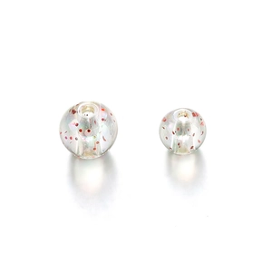 Macro-opname van regenboogkralen met rode glitters en gaten voor het maken van DIY-sieraden
