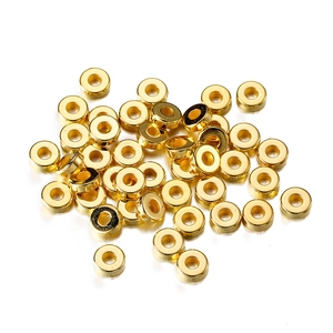 Macro shot of polished gold-plated metal rondelle spacer beads for DIY jewelry making