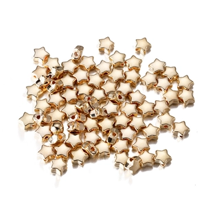 Macro shot of gold star-shaped CCB spacer beads with center holes for DIY jewelry