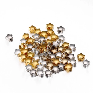 Close-up of gold and silver star-shaped CCB spacer beads with holes for DIY jewelry making