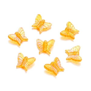 Macro detail of 13mm amber-toned acrylic butterfly beads for DIY jewelry making