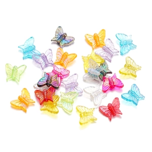 Macro shot of 13mm acrylic butterfly beads with iridescent AB coating for DIY crafts