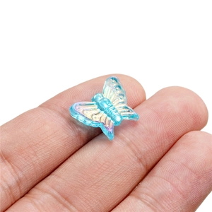 Mini 13mm translucent sky blue iridescent butterfly acrylic bead held by fingers