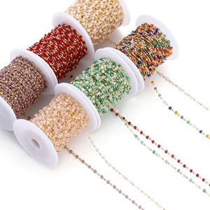 Close-up of colorful cube beads on gold chains for DIY jewelry making and craft