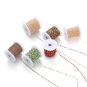 Macro view of crystal beaded chains in various colors on white spools for DIY jewelry making