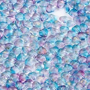 Macro shot of heart-shaped blue and purple glass beads with gold foil for DIY jewelry