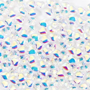 Macro detail of translucent iridescent heart-shaped acrylic beads for DIY jewelry making