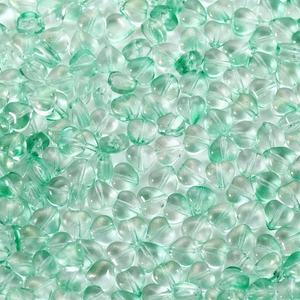 Macro detail of mint green heart glass beads with glitter for DIY jewelry making