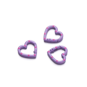 Close-up of 24mm purple heart-shaped metal spring rings with pink polka dot pattern