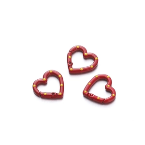 Detail of red heart-shaped spring rings with yellow polka dots for DIY keychains