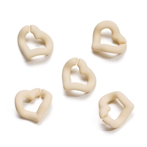 Detailed view of five matte beige heart-shaped acrylic chain links for DIY jewelry