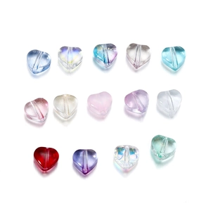 Macro view of colorful heart-shaped glass beads with hole for DIY jewelry making