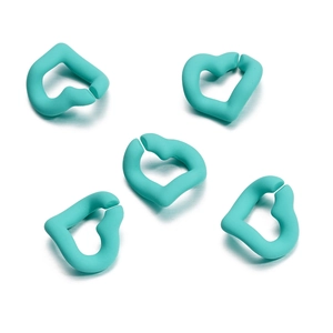 Macro view of mint green heart-shaped DIY link rings with matte textured finish