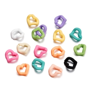 Macro shot of colorful matte acrylic heart-shaped open rings for DIY phone chain making